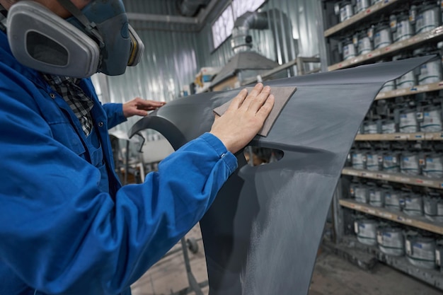 Portrait of male in respirator hard working in workshop