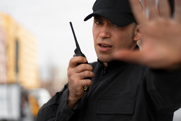 Photo portrait of male security guard with radio station