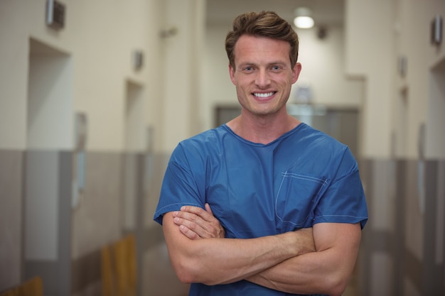 Portrait of male surgeon standing in corridor