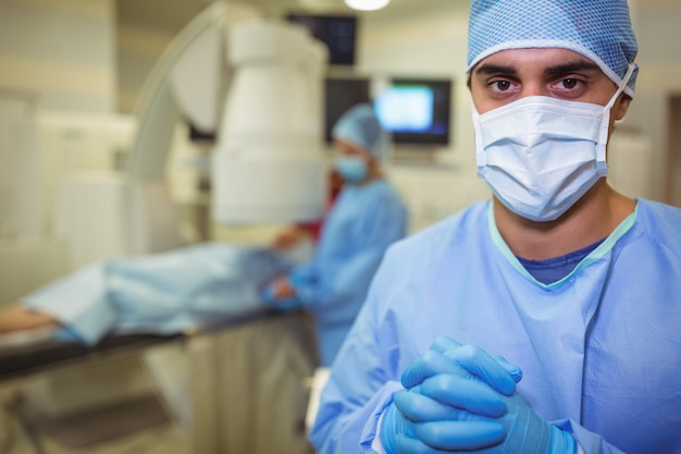 Portrait of male surgeon standing in operation theater