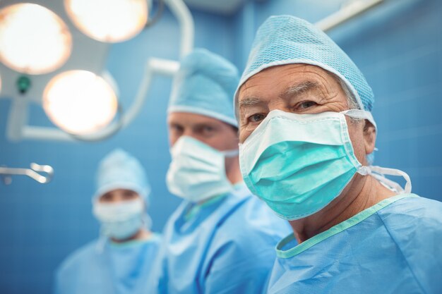 Portrait of male surgeon wearing surgical mask in operation theater