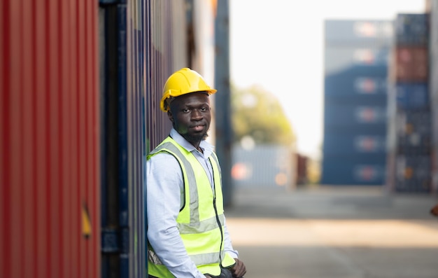 Portrait of male worker in front of container
