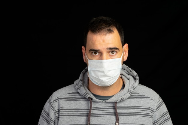 Portrait of man against black background