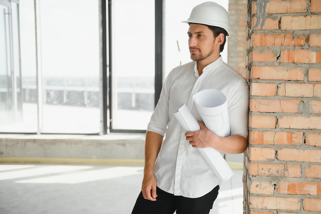 Portrait of man architect at building site Confident construction manager wearing hardhat Successful mature civil engineer at construction site with copy space