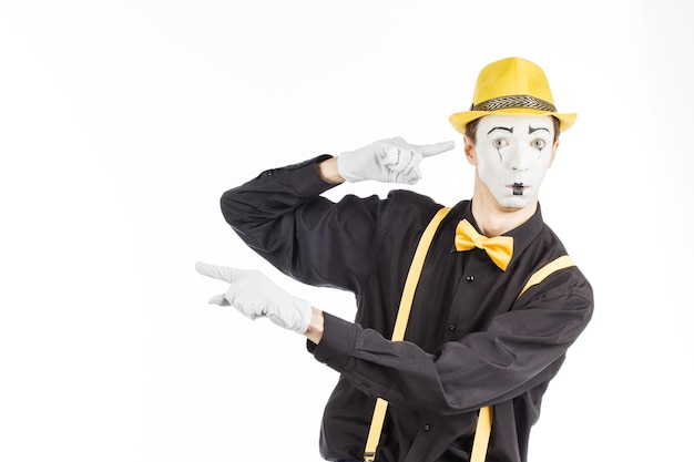 Portrait of a man an artist a pantomime Shows something isolated on white background