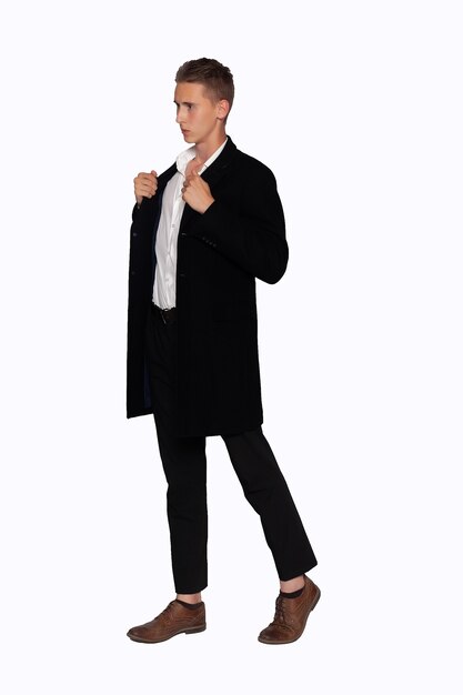 Portrait of a man in a black coat and trousers on a white background