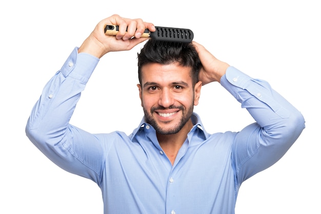 Portrait of a man combing his hair