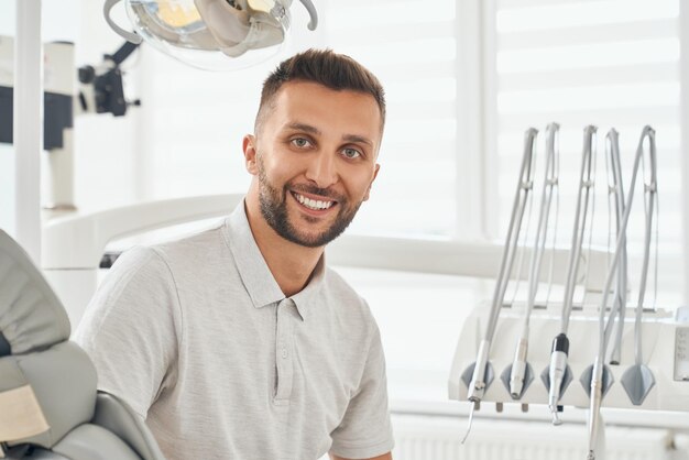 Portrait of man in dental chair after hygiene procedure