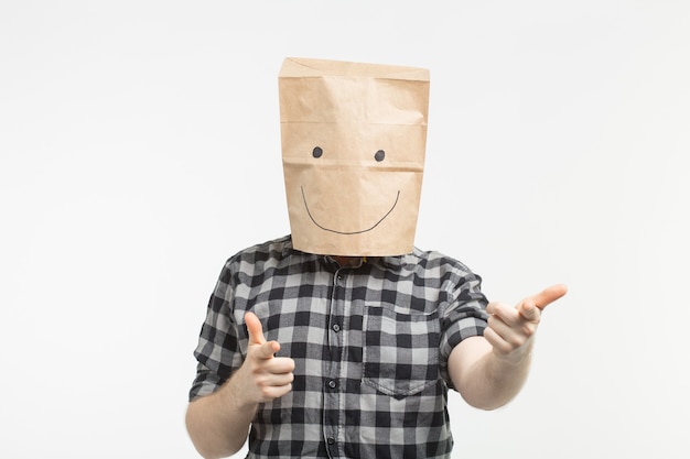 Portrait of man in happy paper bag mask on white background