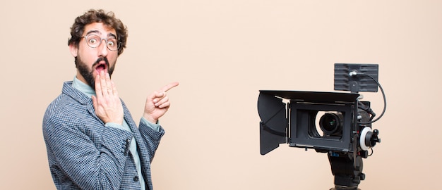 portrait of a man and his camera on a cream background