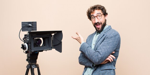 portrait of a man and his camera on a cream background