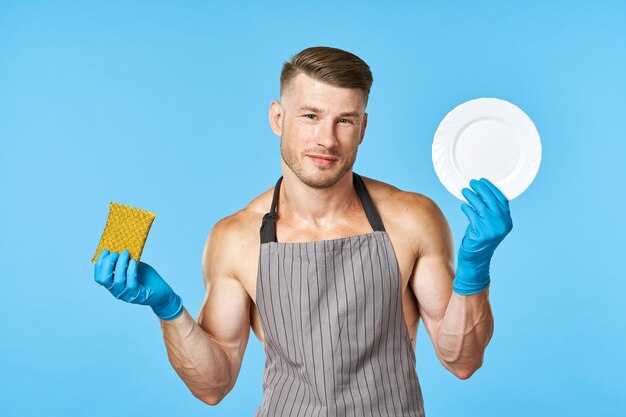 Portrait of man holding camera against blue background