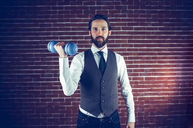 Portrait of man holding dumbbell