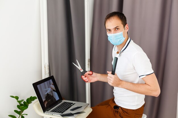 Portrait of a man makes a haircut for himself during\
quarantine