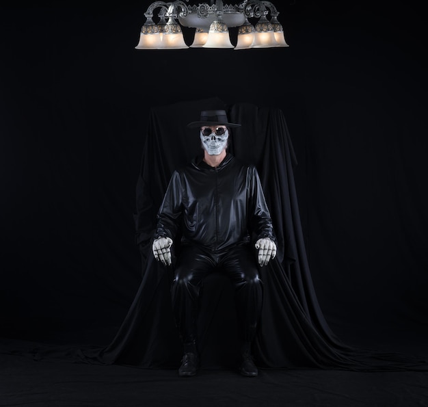 Photo portrait of a man in a monster mask on a black background