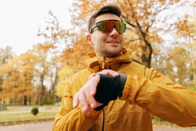 Portrait of a man Motivation for an active life A running coach uses a smart watch and a fitness