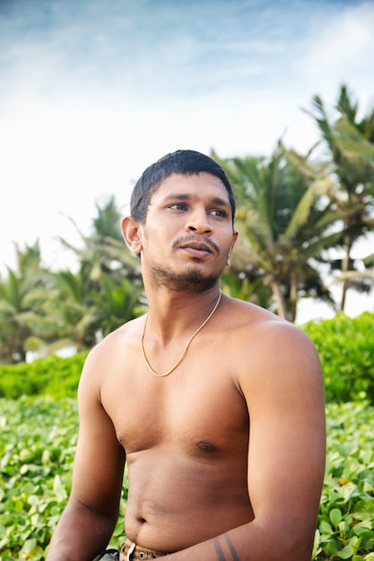 Portrait of a man near palm trees