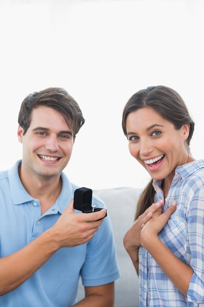 Portrait of a man offering an engagement ring to his partner