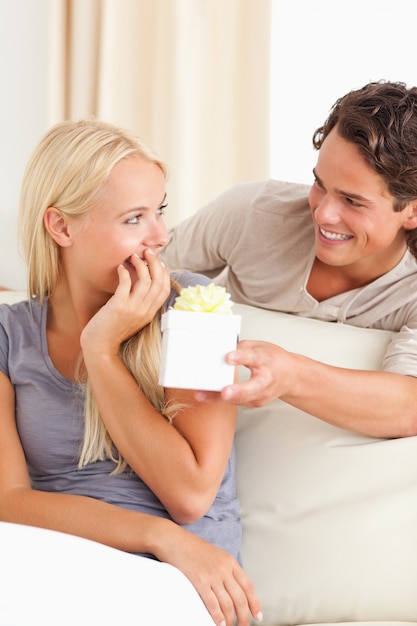 Portrait of a man offering a present to his girlfriend