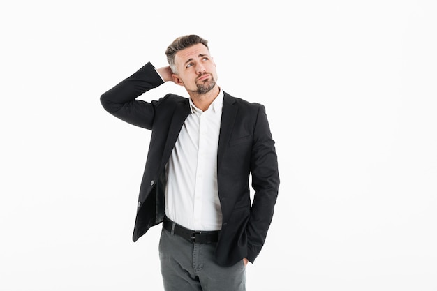 Portrait of man in office wearing jacket looking aside and touching his head, isolated over white