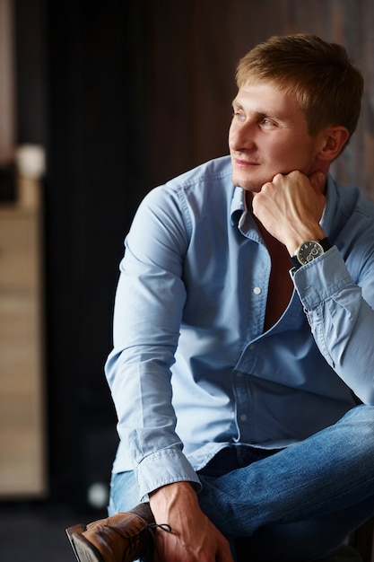 Portrait of man in official shirt that posing for the camera indoors.