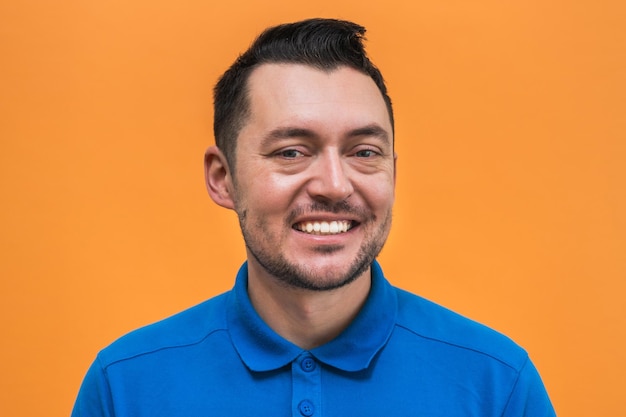 Portrait of the man on orange background Man's emotions