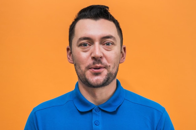 Photo portrait of the man on orange background man's emotions