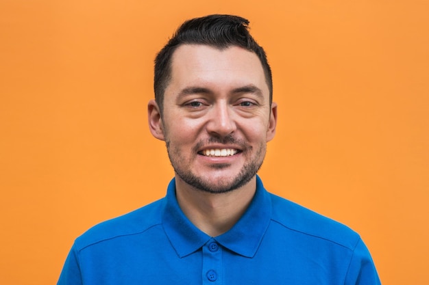 Portrait of the man on orange background Man's emotions