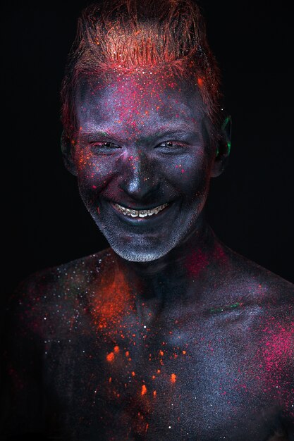 Portrait of a man painted in fluorescent UV colors.