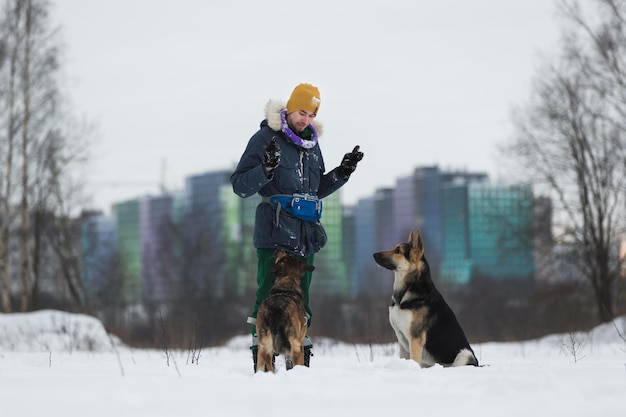 Portrait of a Man playing with a German shepherd in the Park in the winter