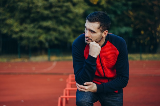 a portrait of a man in a red jacket