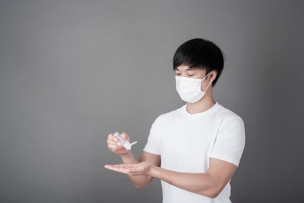 Portrait of Man sanitizing hands with alcohol gel, Health care concept