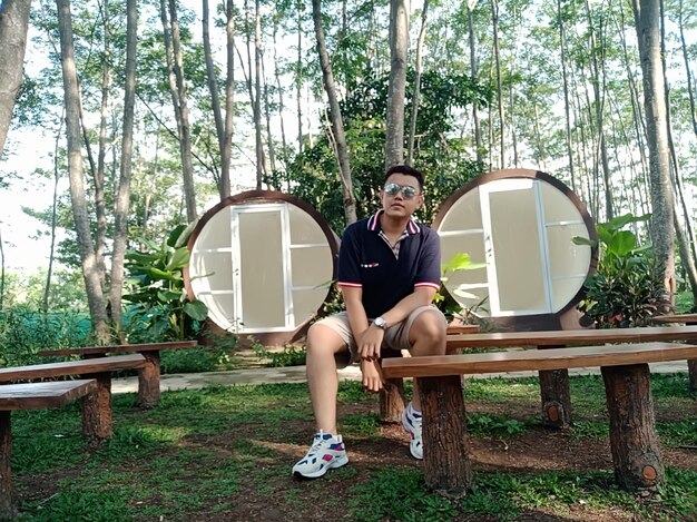 Portrait of man sitting on bench