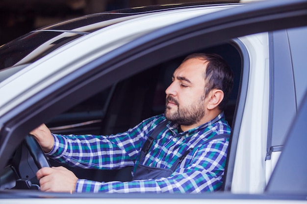 Portrait of man sitting in car