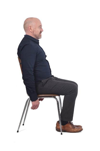 Portrait of a man sitting on a chair in white background,