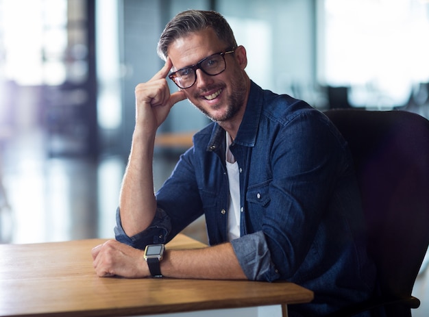 Portrait of man sitting in office