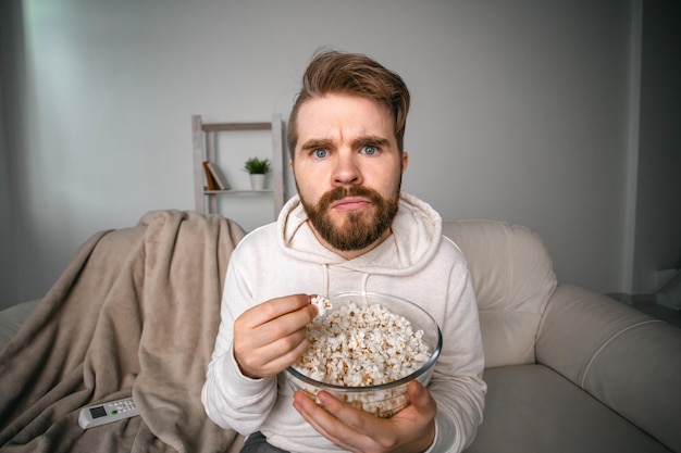 Portrait of man sitting on sofa at home