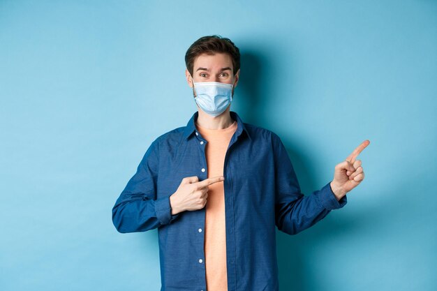 Portrait of man standing against blue background