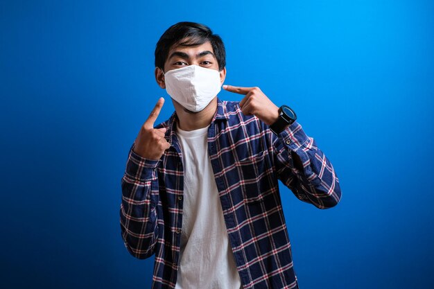 Portrait of man standing against blue background