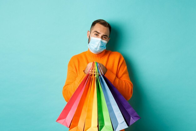 Portrait of man standing against multi colored background