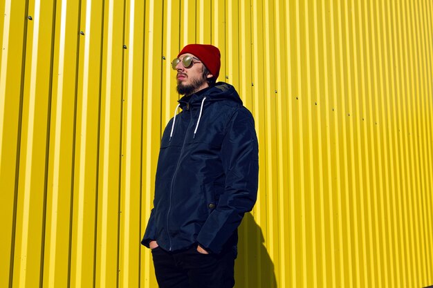 Portrait of man standing against wall