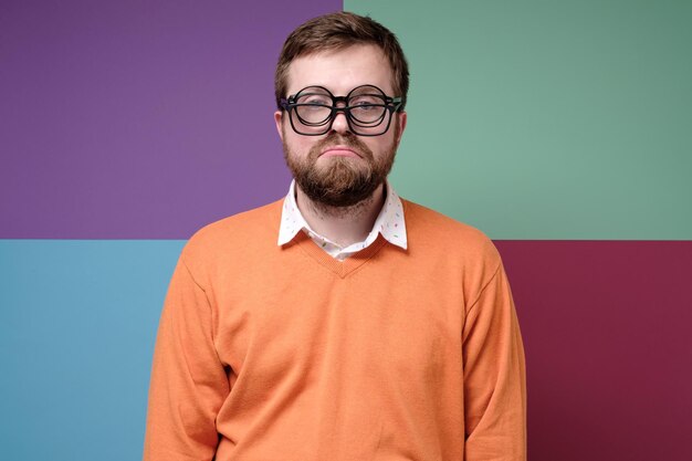 Portrait of man standing against wall