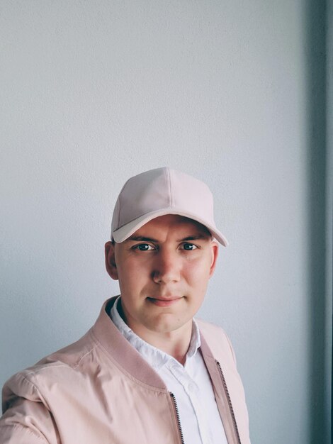 Portrait of man standing against wall