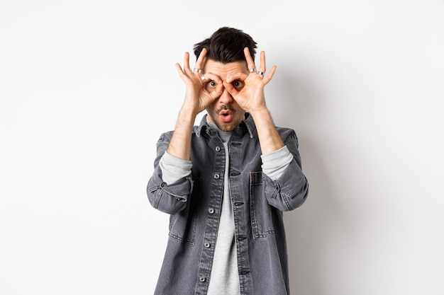 Portrait of man standing against white background