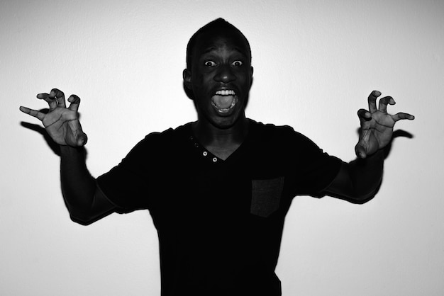 Portrait of man standing against white background