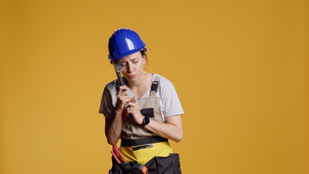 Portrait of man standing against yellow background