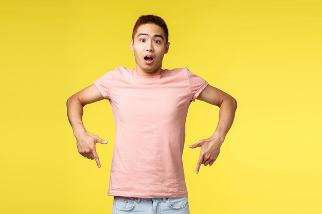 Portrait of man standing against yellow background