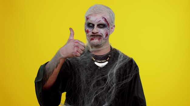 Portrait of man standing against yellow background