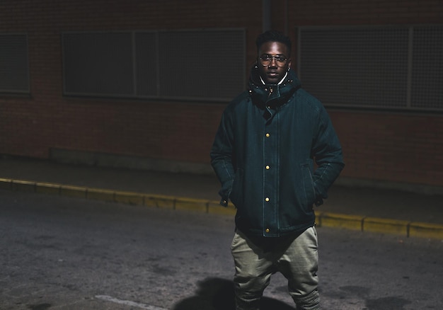 Portrait of man standing in city at night