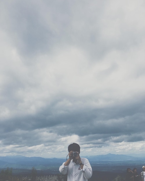 Photo portrait of man standing on mountain against sky